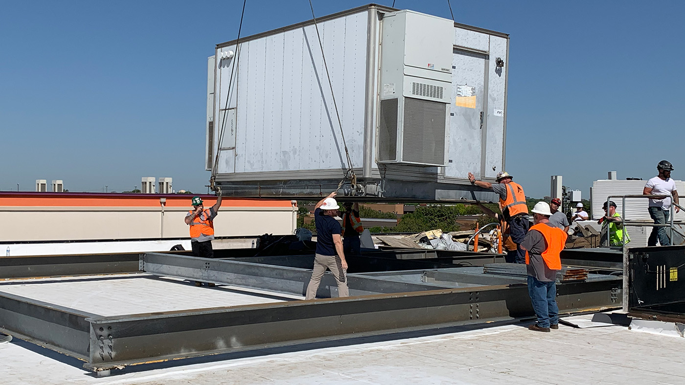 Roofing crew working on a commercial roof in Dallas, TX